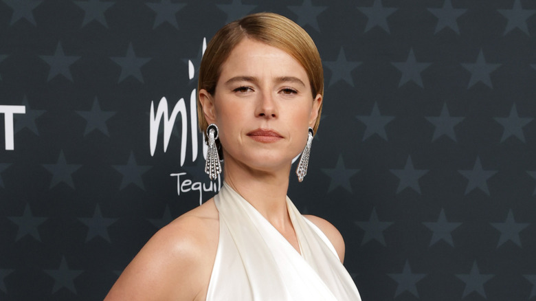 Jessie Buckley posing on step-and-repeat