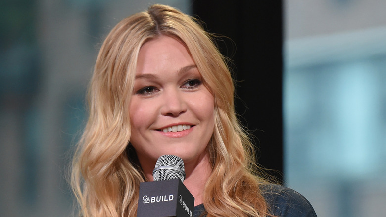 Julia Stiles holding a microphone