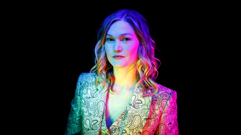 Julia Stiles black background staring