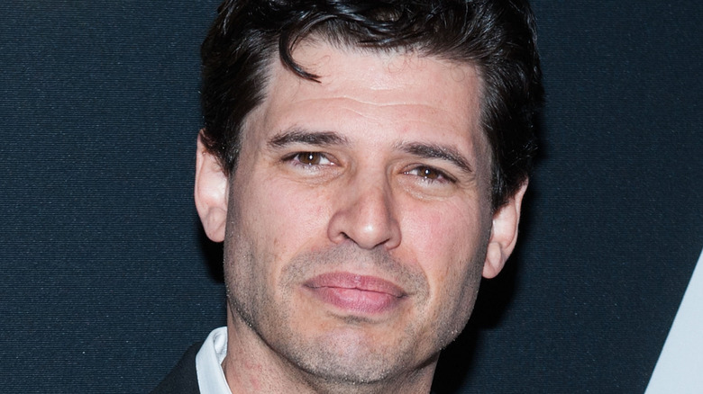 Max Brooks posing at event