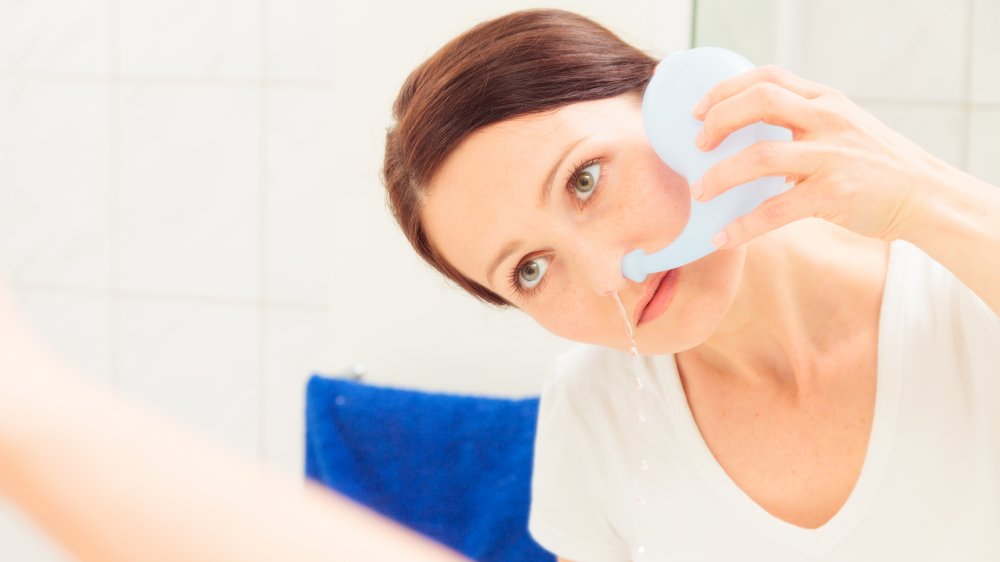 Woman using neti pot