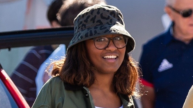 Sasha Obama wearing a hat and jacket