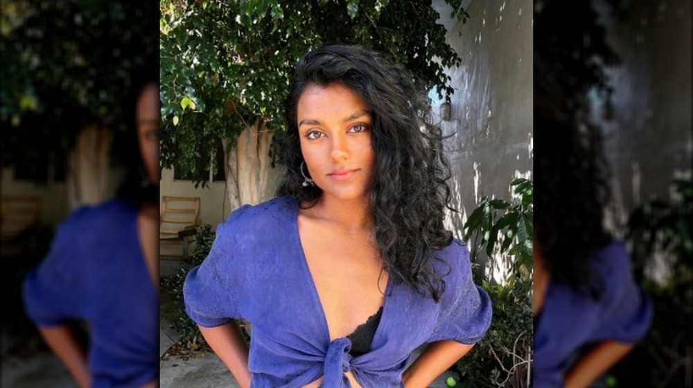 Simone Ashley wearing a purple top