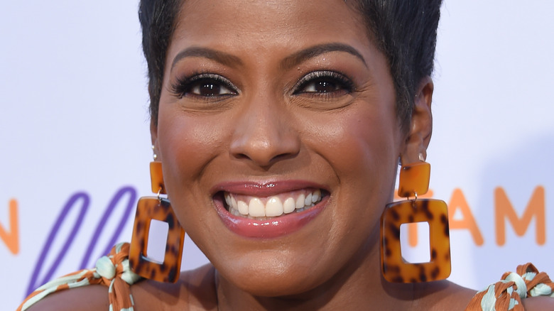 Tamron Hall smiling, wearing earrings