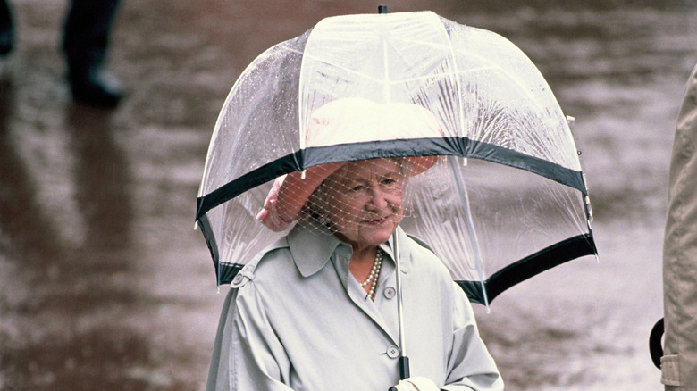 Queen Mother walking in the rain