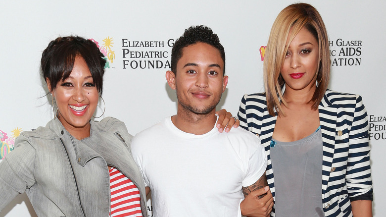 Tia Mowry posing with Tahj and Tamera Mowry
