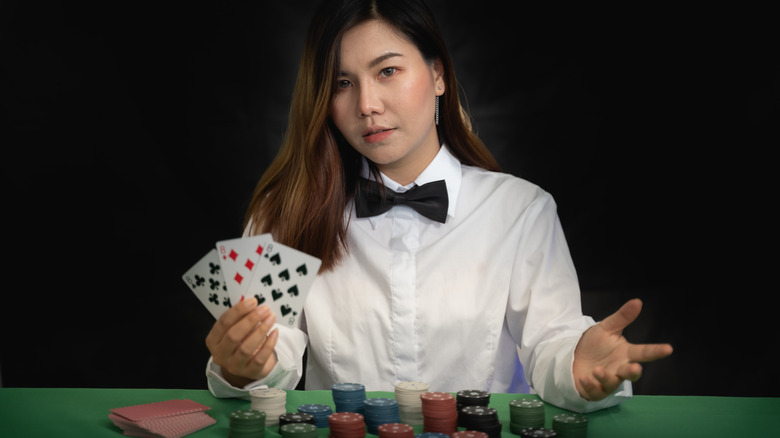 Woman holding playing cards