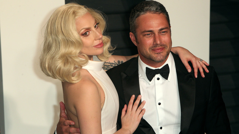 Lady Gaga with her arms around Taylor Kinney