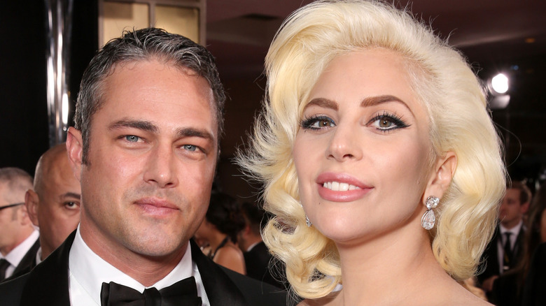 Taylor Kinney and Lady Gaga in front of a crowd