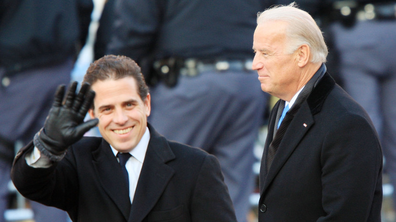 Hunter Biden smiling and waving to camera next to Joe Biden