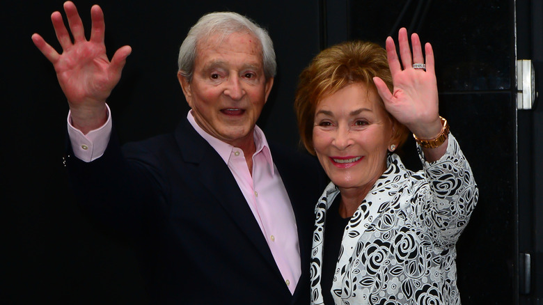 Judy and Jerry Sheindlin smiling and waving on the set of "Good Morning America" in 2015