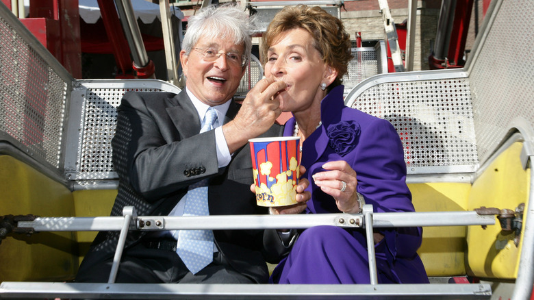 Jerry Sheindlin feeding Judy Sheindlin popcorn on an amusement park ride
