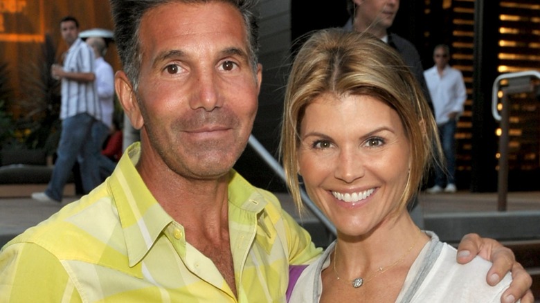 Mossimo Giannulli with his hand on Lori Loughlin's shoulder