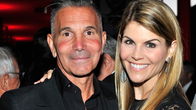 Mossimo Giannulli and Lori Loughlin smiling an event in 2015