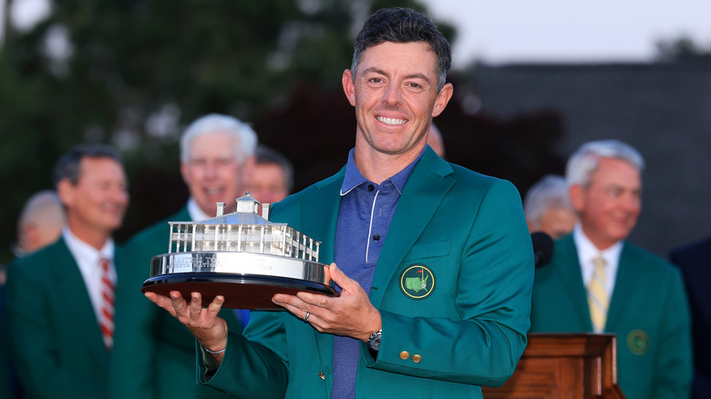 Rory McIlroy smiling and holding a trophy
