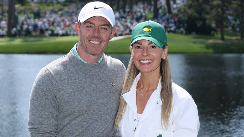 Rory McIlroy and Erica Stoll wearing baseball caps