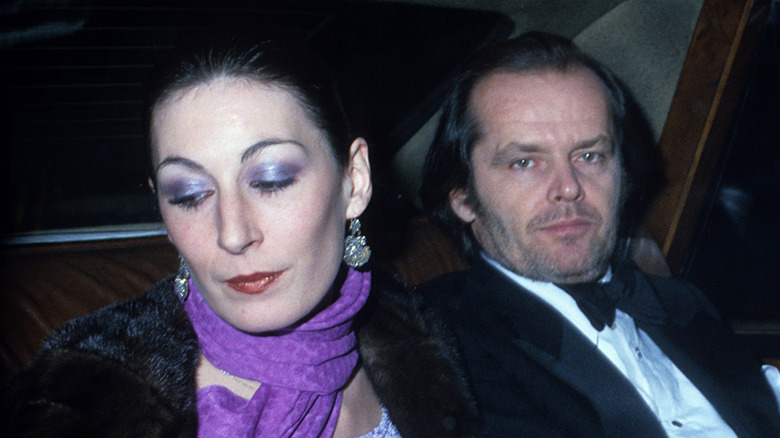 Anjelica Huston and Jack Nicholson sitting in a car together