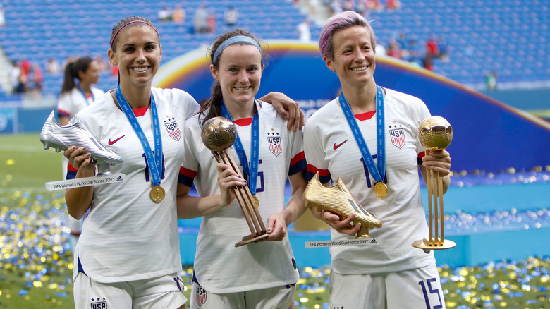 Alex Morgan, Rose Lavelle, and Megan Rapinoe smiling 