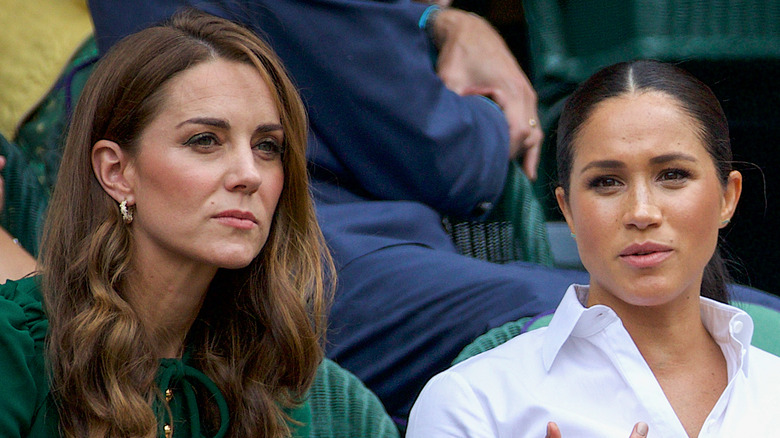 Catherine, Duchess of Cambridge sits with Meghan in 2019