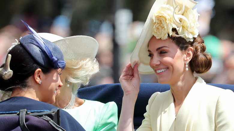 Kate and Meghan riding in a carriage in 2019