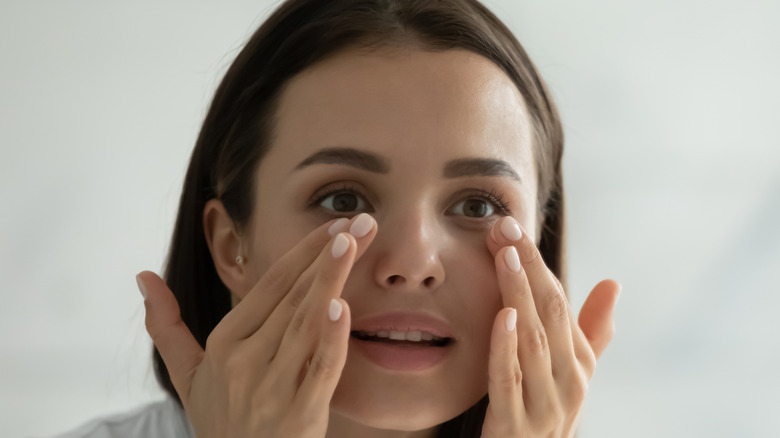 Woman applying moisturizer