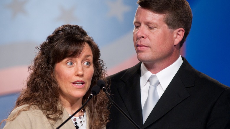 Michelle and Jim Bob Duggar speaking onstage