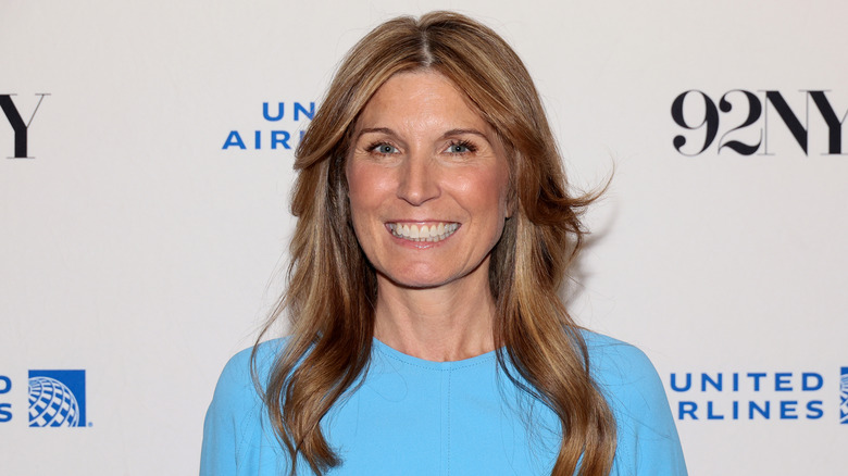 Nicolle Wallace smiling at an event in a light blue dress