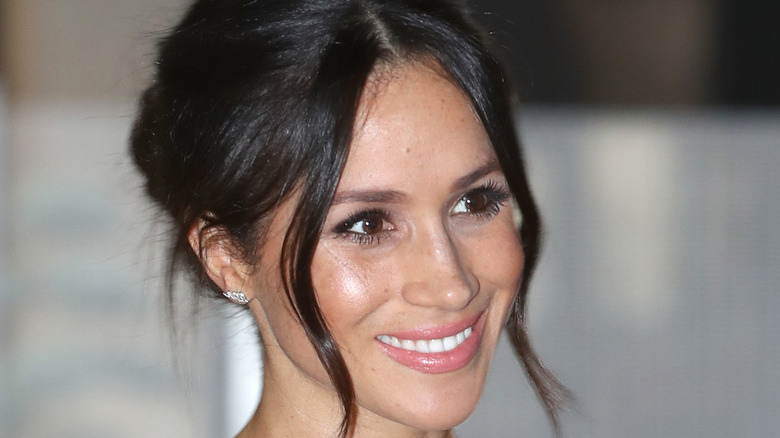 Meghan Markle smiling in black