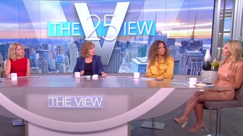 The cast of the view sitting around the table