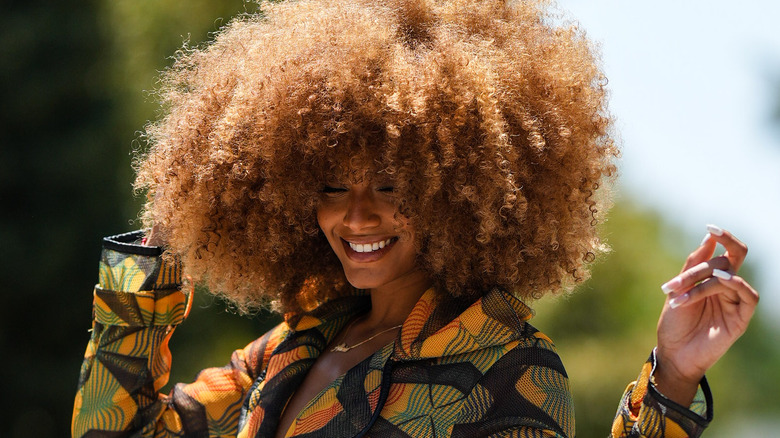 woman with afro with hand in hair