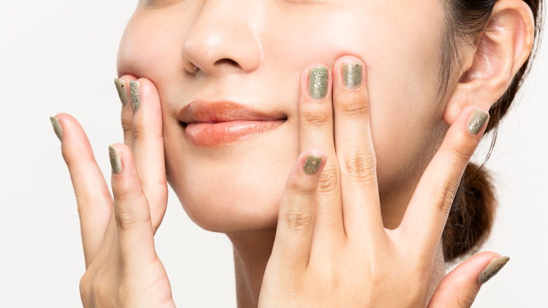 Closeup woman doing facial massage