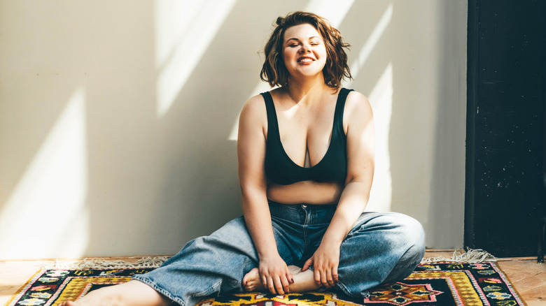 woman relaxing in bra, jeans