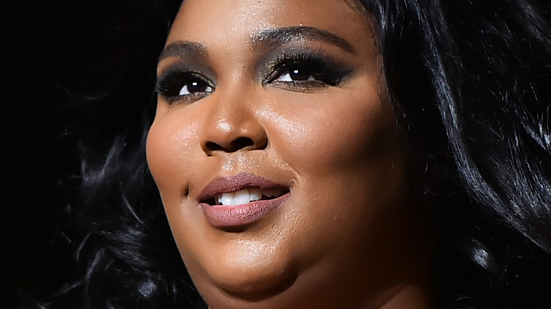 Lizzo smiling on stage