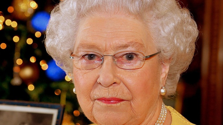 Queen Elizabeth in front of holiday decor