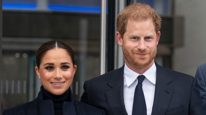 Prince Harry and Meghan Markle posing at event