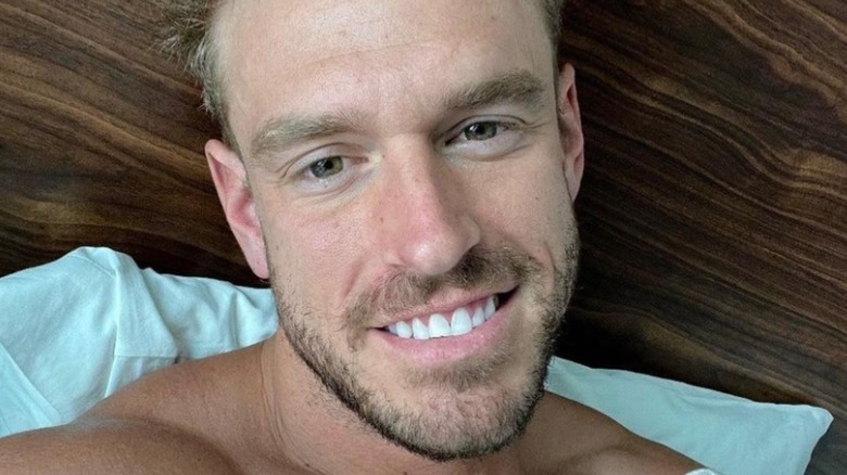 Shayne Jansen smiling in selfie from bed 