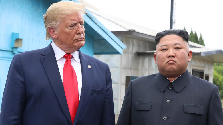 Donald Trump looks over at Kim Jong-Un