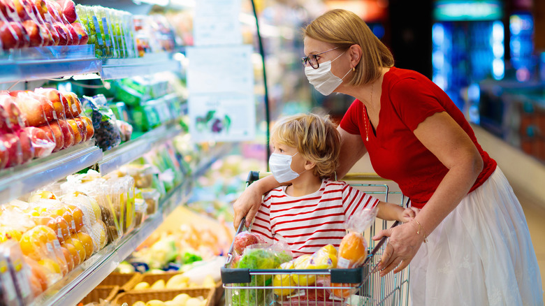 Mother and child grocery shopping