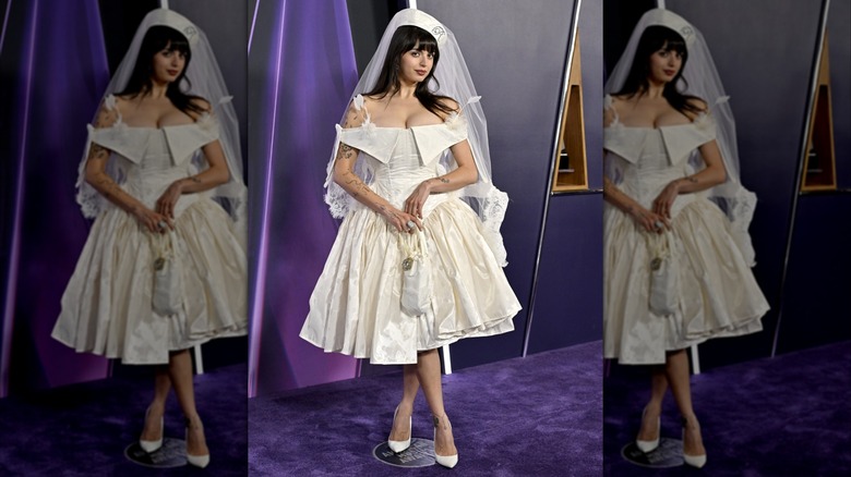 Rebecca Black posing in a wedding style dress