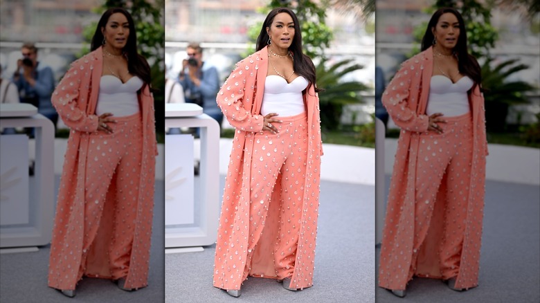 Angela Bassett posing in a peach pansuit