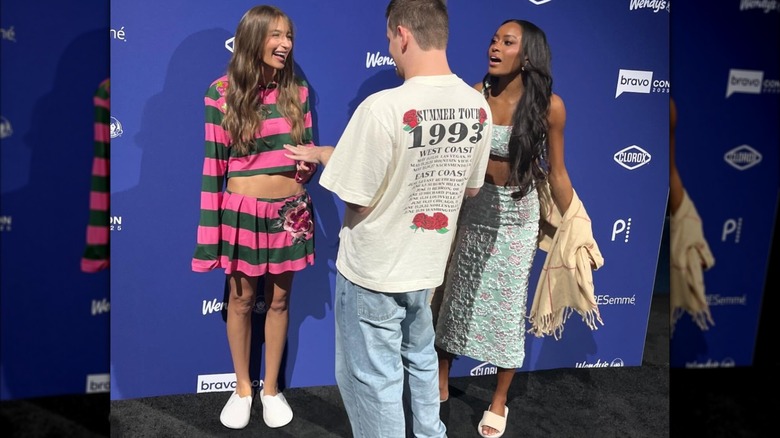 Amanda Batula and Ciara Miller laughing with a fan