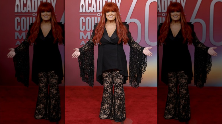 Wynonna Judd posing in all black lacy outfit