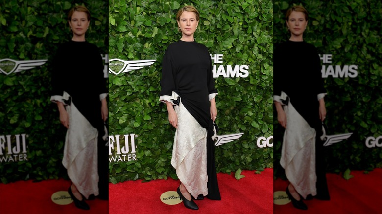 Jessie Buckley posing in black and white dress