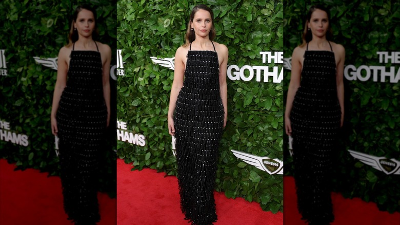 Felicity Jones posing in a black dress