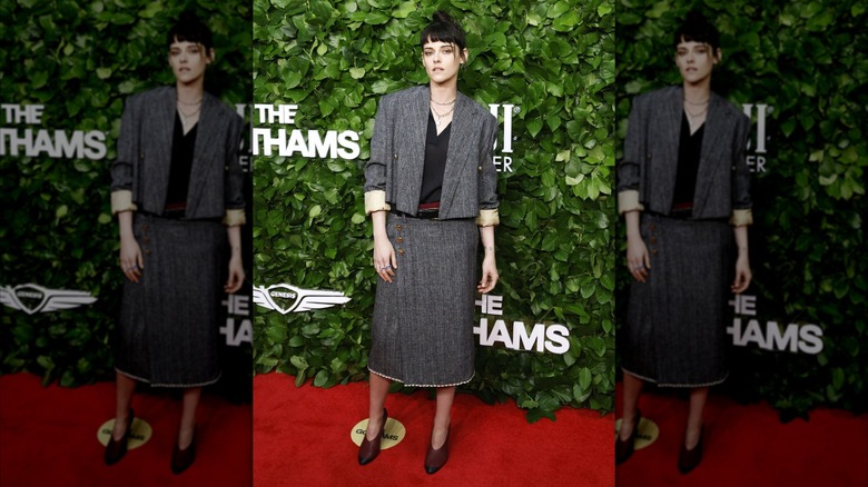 Kristen Stewart posing in a skirt and jacket