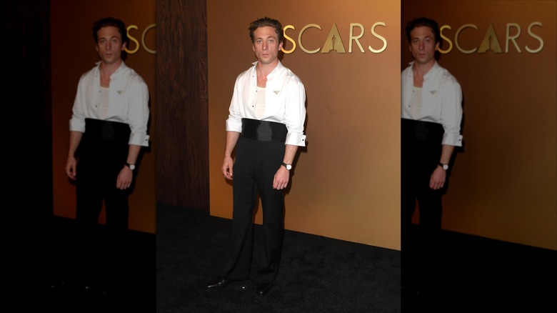 Jeremy Allen White in a white shirt and black pants on the black carpet for the Governors Awards.