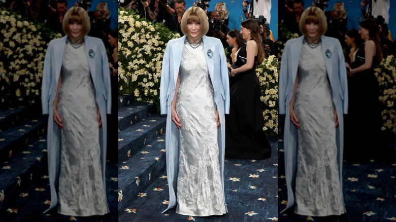 Anna Wintour poses in a white dress with blue coat