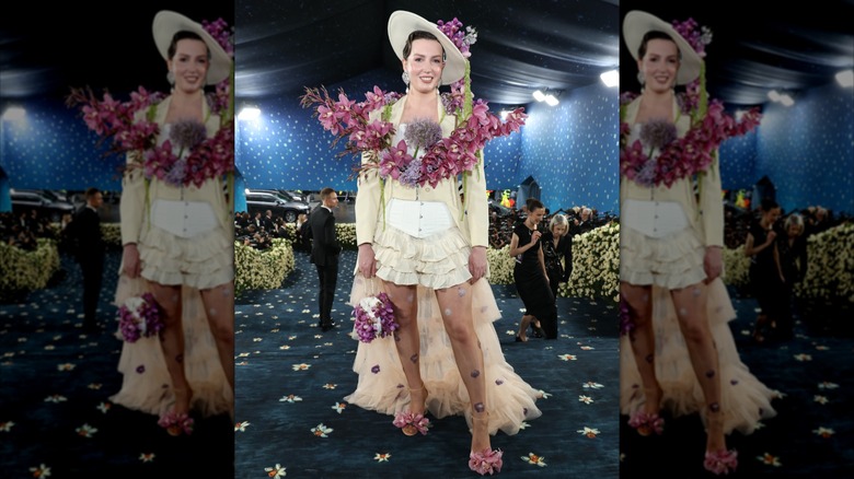 Jessica Kayll wears an outfit with giant fake flowers on it