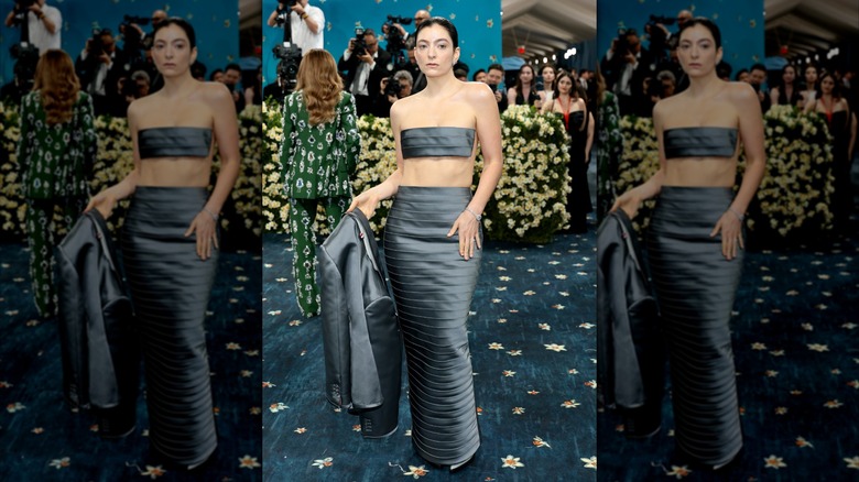 Lorde poses in a skirt and piece of material as a top