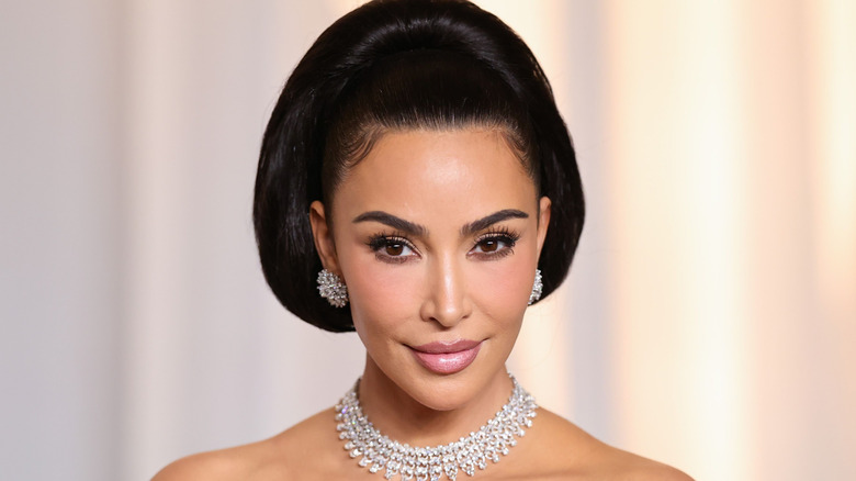 Kim Kardashian smiles with diamond jewelry